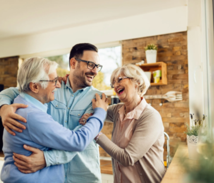 happy-mature-parents-having-fun-while-embracing-their-adult-son-who-came-visit-them-home-scaled